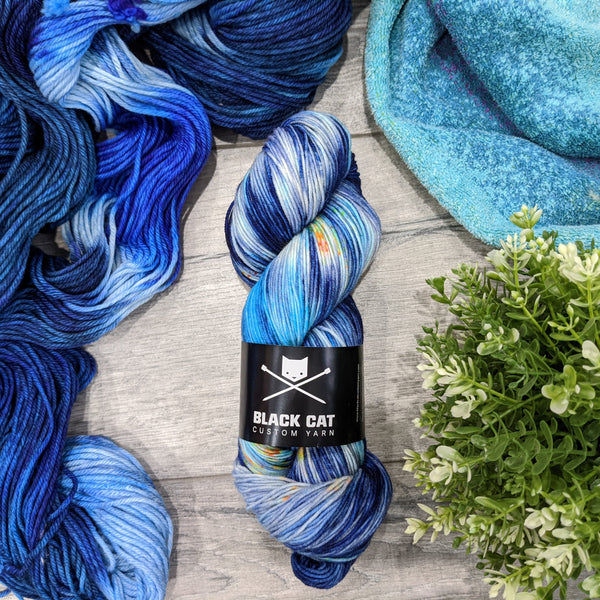 A blue skein of yarn on a wooden background.